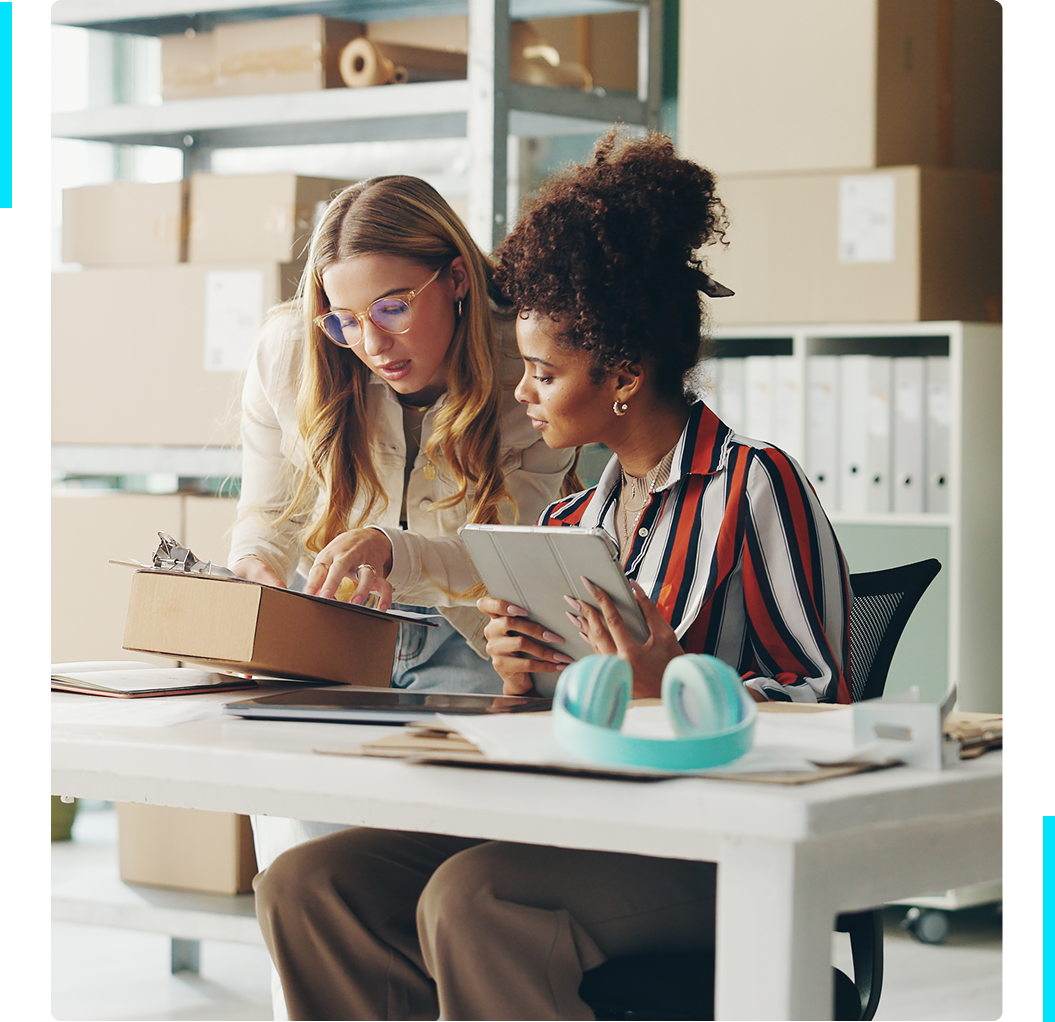 Group 1321317223 Two women working with packages and tablet.